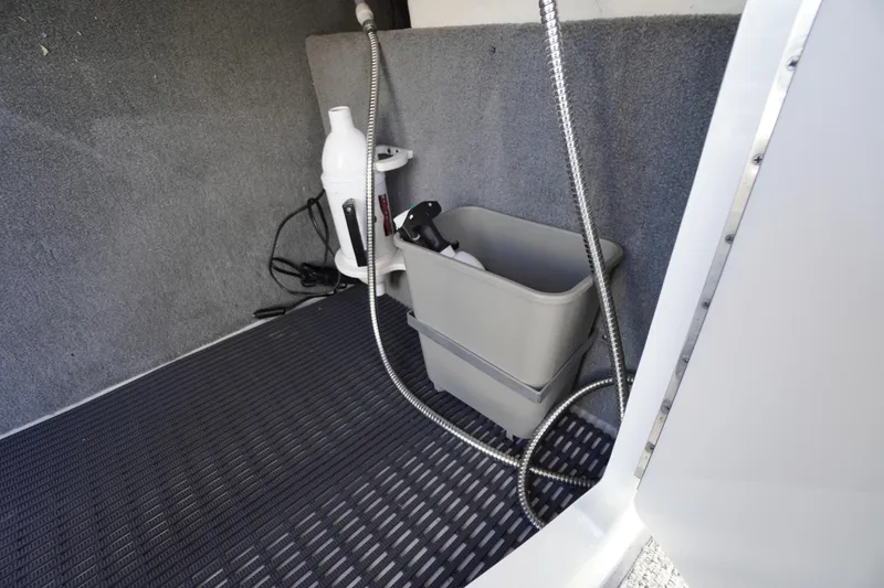 Slide: The Image of Interior storage area of 2014 Chaparral 287 SSX boat with cleaning supplies. - 35