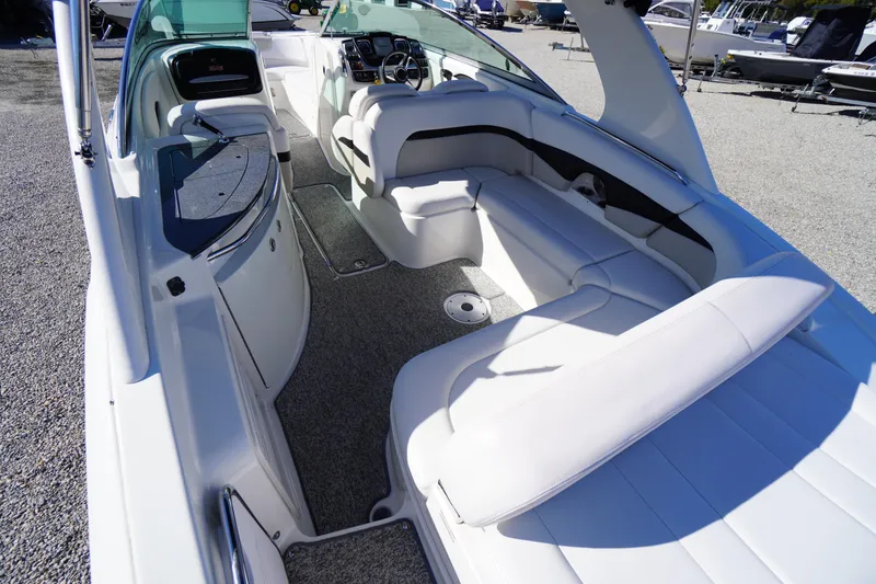 Slide: The Image of 2014 Chaparral 287 SSX boat interior with white seating and modern dashboard. - 38