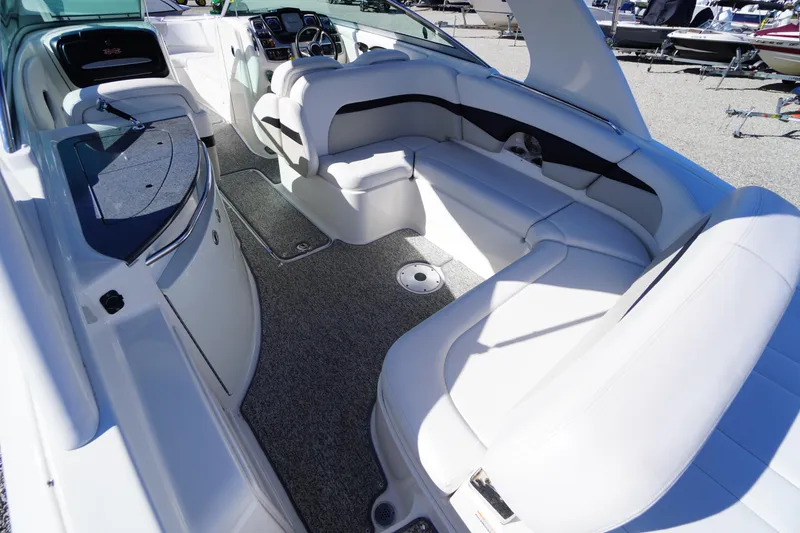 Slide: The Image of 2014 Chaparral 287 SSX boat interior with white seating and modern dashboard. - 39