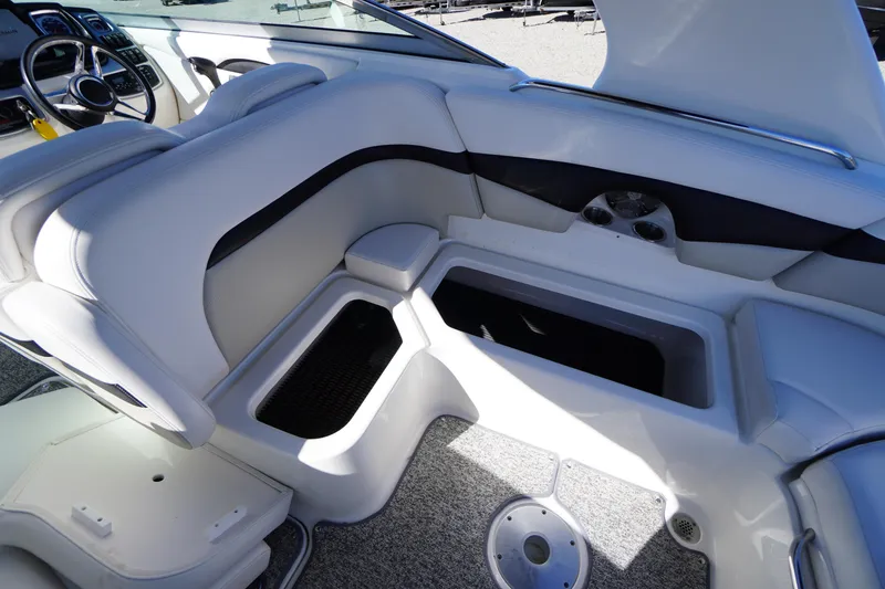 Slide: The Image of 2014 Chaparral 287 SSX boat interior with white seating and storage compartments. - 41