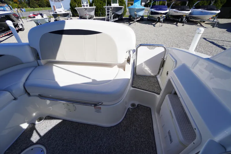 Slide: The Image of 2014 Chaparral 287 SSX boat interior with seating and open door, showcasing luxury design. - 48