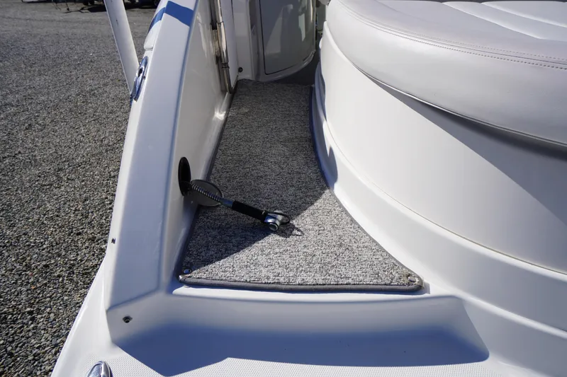 Slide: The Image of 2014 Chaparral 287 SSX boat interior with carpeted step and seating area. - 49