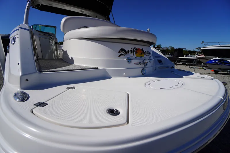 Slide: The Image of 2014 Chaparral 287 SSX boat with spacious deck and seating, under clear blue sky. - 55