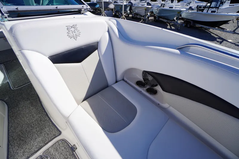 Slide: The Image of 2014 Chaparral 287 SSX boat interior seating with cup holders, showcasing luxury design. - 6