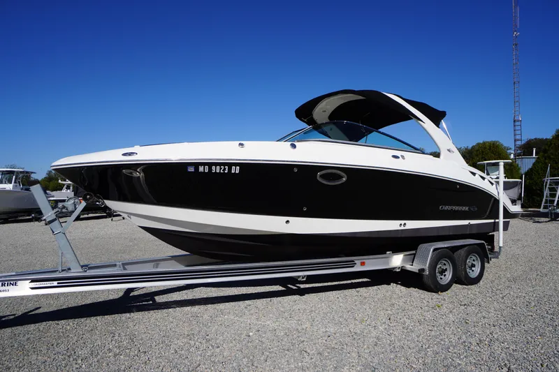 Slide: The Image of 2014 Chaparral 287 SSX boat on trailer, black and white design, parked outdoors. - 62
