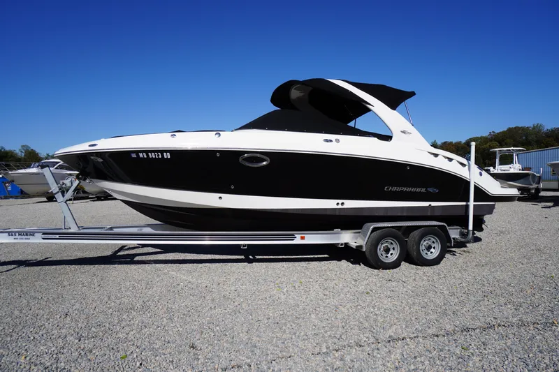 Slide: The Image of 2014 Chaparral 287 SSX boat on trailer, black and white design, parked outdoors. - 63