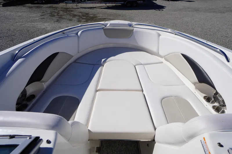 Slide: The Image of 2014 Chaparral 287 SSX boat interior with white cushioned seating. - 7