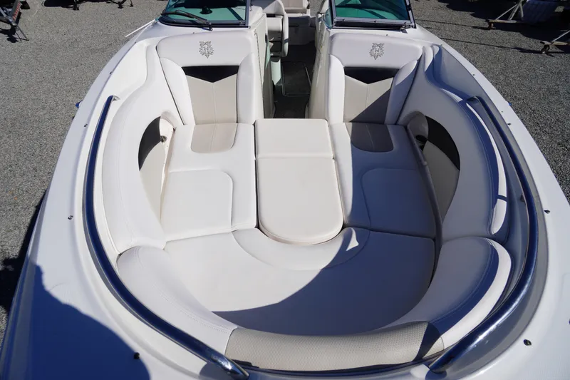 Slide: The Image of 2014 Chaparral 287 SSX boat interior with white cushioned seating and sleek design. - 9