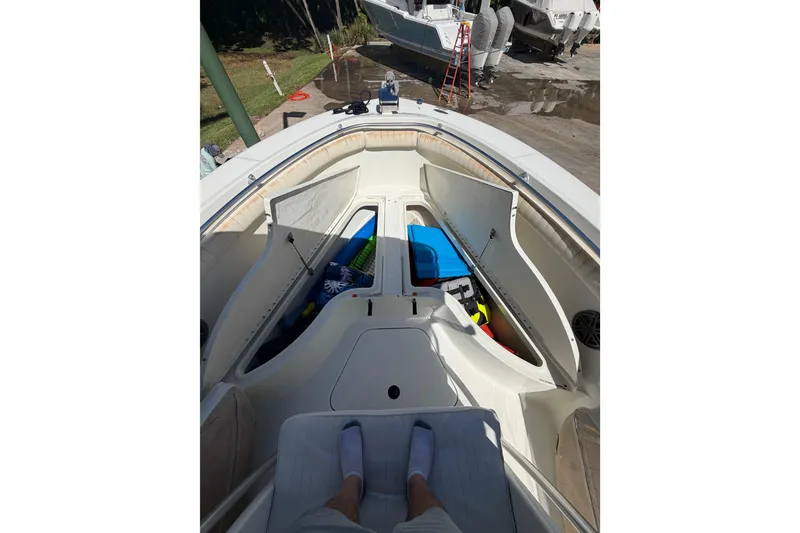 Slide: The Image of 2000 Hydra-Sports 2500 CC boat interior with open storage compartments and visible gear. - 10