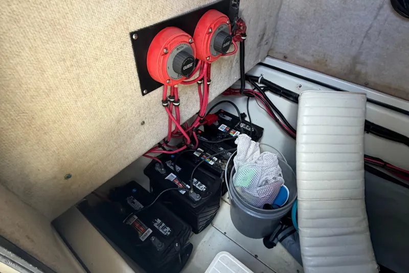 Slide: The Image of Hydra-Sports 2500 CC 2000 boat battery compartment with switches and storage bucket. - 11