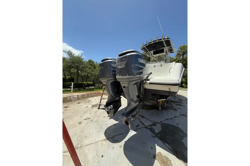 Slide: The Image of 2000 Hydra-Sports 2500 CC boat with dual Yamaha 225 engines, parked outdoors. - 15