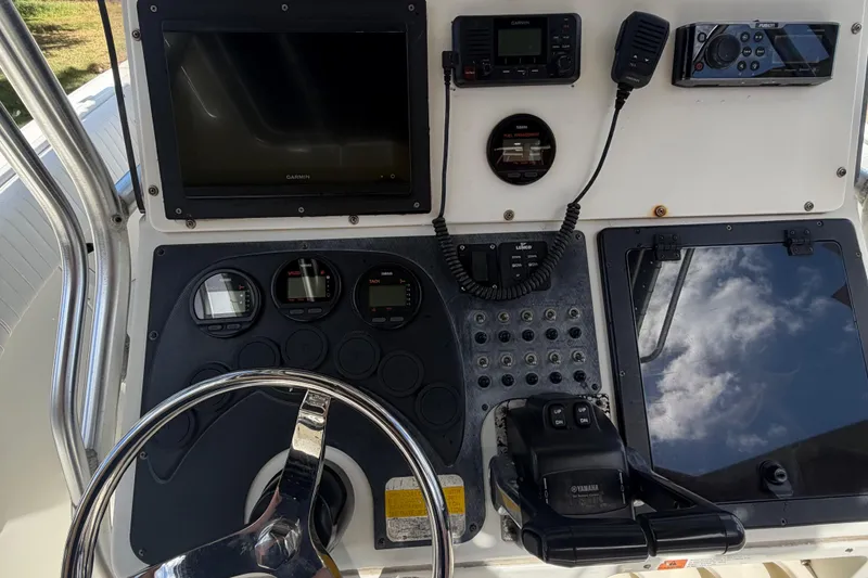 Slide: The Image of Hydra-Sports 2500 CC 2000 boat dashboard with steering wheel, gauges, and electronic controls. - 5