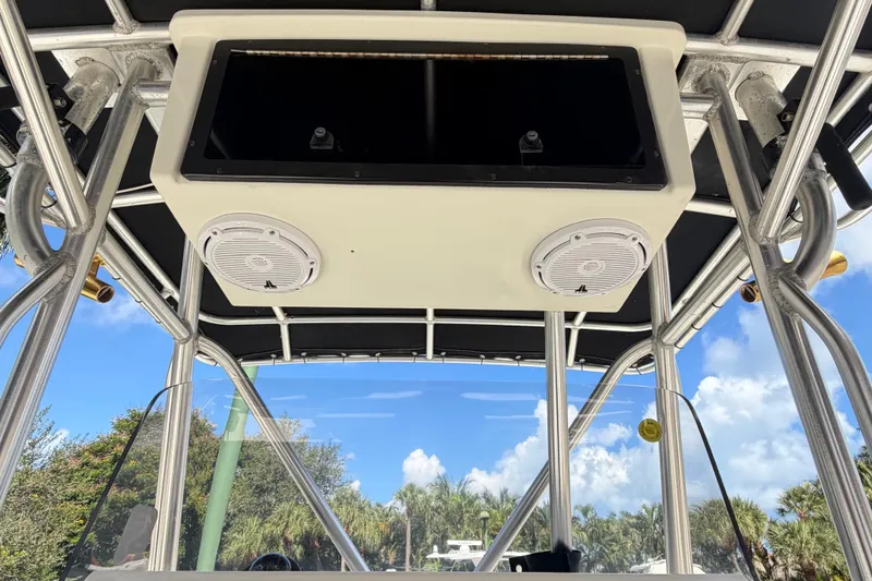 Slide: The Image of T-top view of 2000 Hydra-Sports 2500 CC boat with speakers and clear sky background. - 7