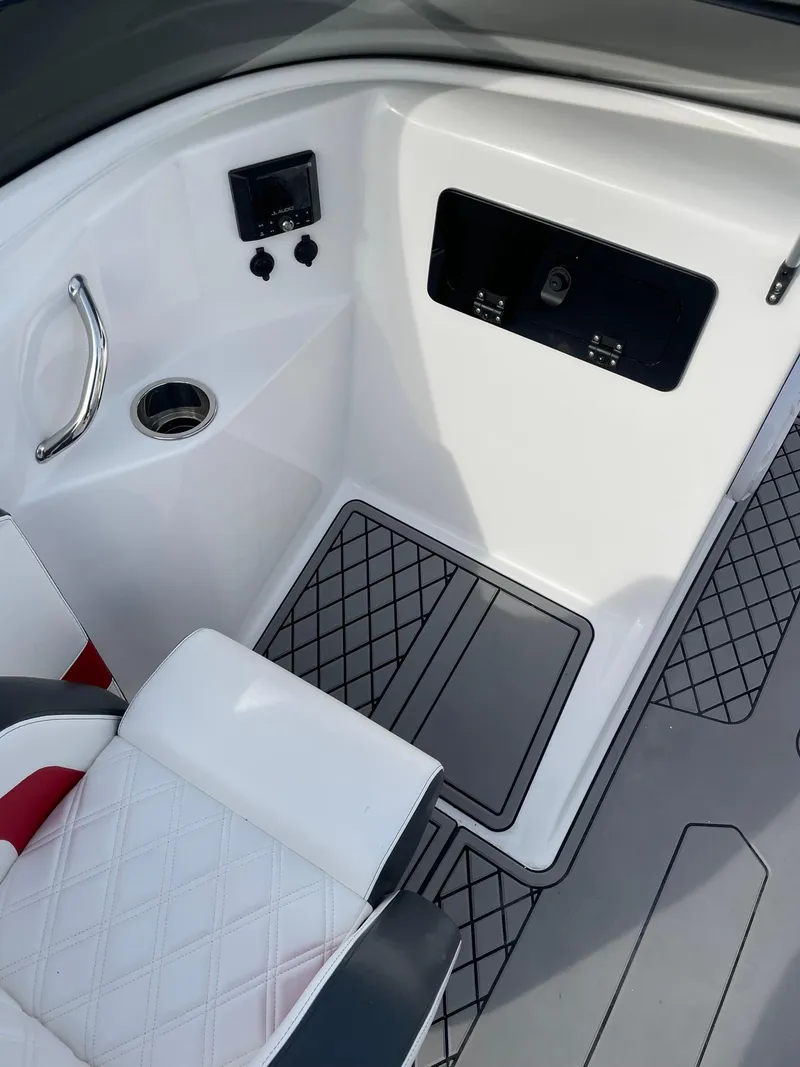 Slide: The Image of 2025 Checkmate Pulsare 2400 BRX boat interior with modern seating and control panel. - 14