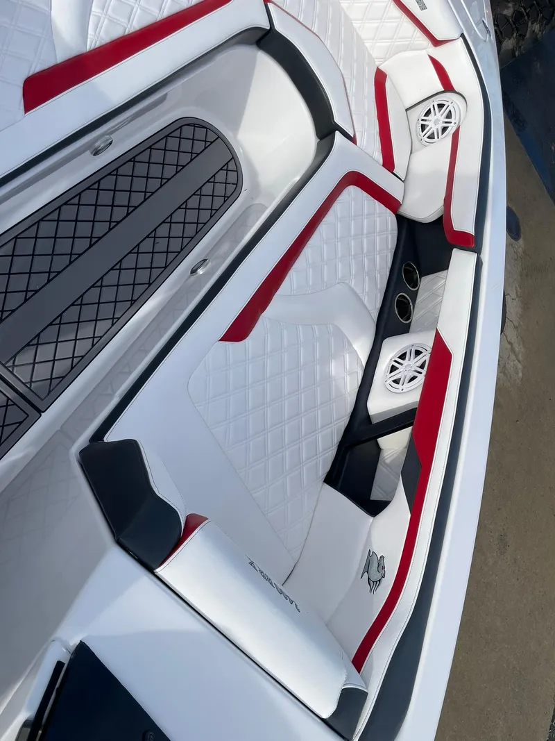 Slide: The Image of 2025 Checkmate Pulsare 2400 BRX boat interior with red accents and diamond-patterned seating. - 16