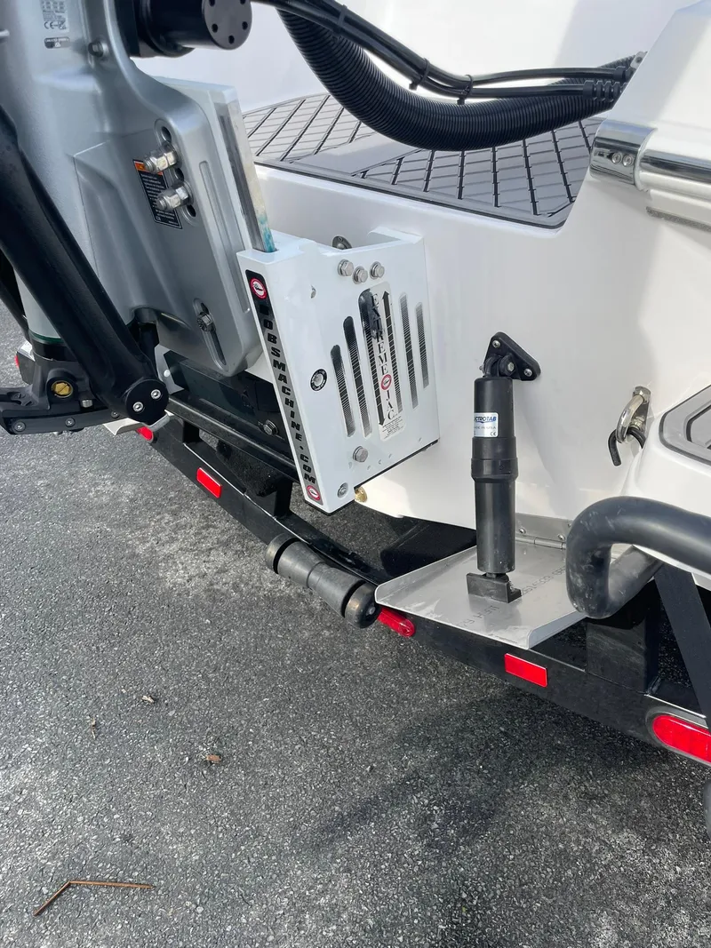 Slide: The Image of 2025 Checkmate Pulsare 2400 BRX boat trailer detail with hydraulic components. - 4