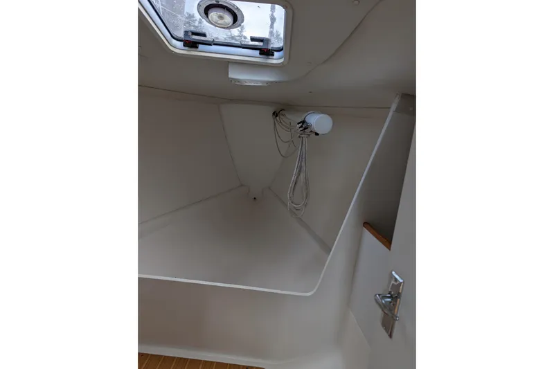 Slide: The Image of 2016 J Boats J 95 interior with striped cushion and wooden accents. - 13