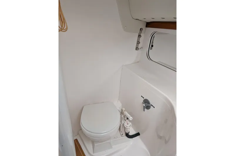 Slide: The Image of 2016 J Boats J 95 interior with striped cushions and wooden flooring. - 14