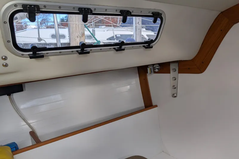Slide: The Image of 2016 J Boats J 95 interior with striped seating and wooden flooring. - 15