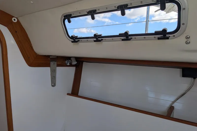 Slide: The Image of Interior seating of 2016 J Boats J 95 with striped and beige cushions. - 16