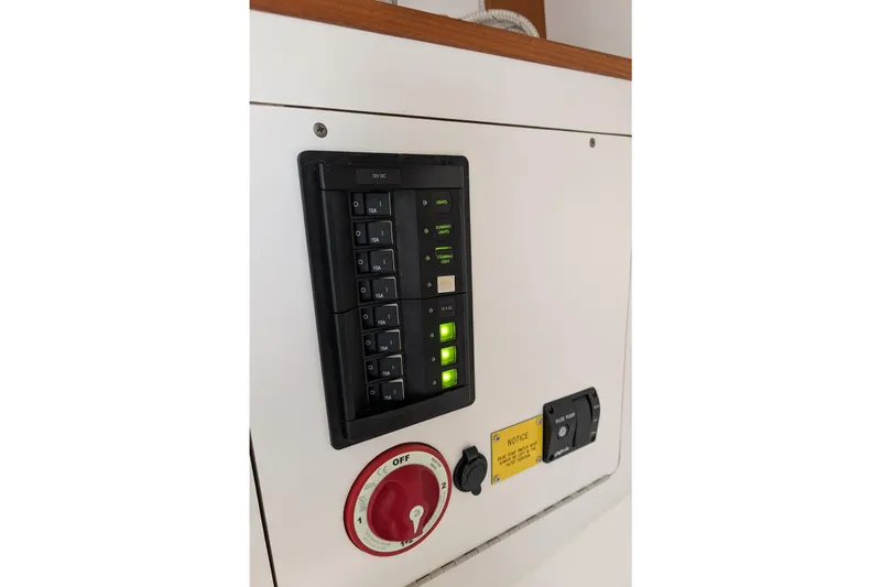 Slide: The Image of Control panel on 2016 J Boats J 95 sailboat, featuring switches and circuit breakers. - 22