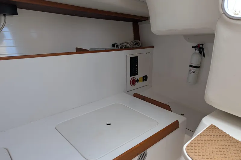 Slide: The Image of Interior of 2016 J Boats J 95 sailboat, featuring control panel and fire extinguisher. - 23