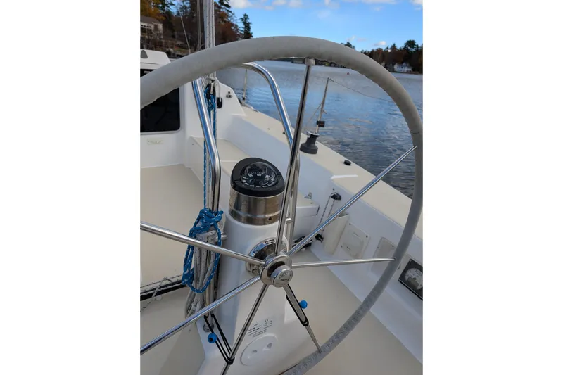 Slide: The Image of 2016 J Boats J 95 sailboat helm with compass, docked by calm waters. - 7