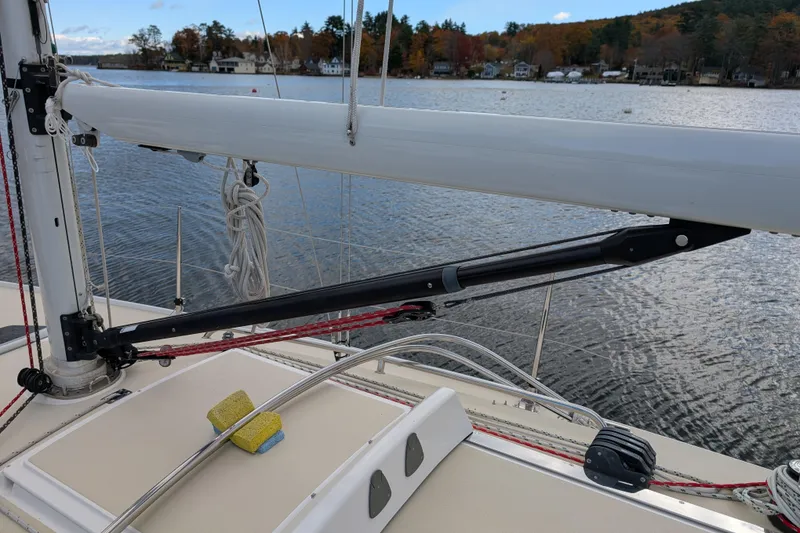 Slide: The Image of 2016 J Boats J 95 sailboat deck with boom and rigging on a calm lake. - 8