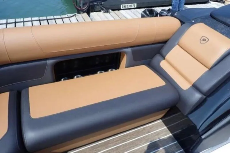Slide: The Image of Luxurious seating on 2025 Premier 250 Solaris RF boat, featuring tan and black upholstery. - 10
