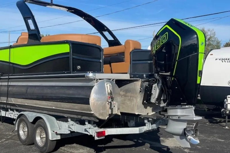 Slide: The Image of 2025 Premier 250 Solaris RF pontoon boat on trailer with powerful outboard motor. - 12