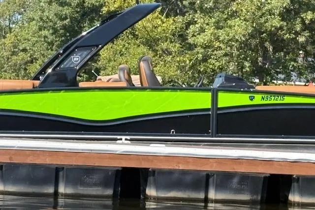 Slide: The Image of 2025 Premier 250 Solaris RF boat docked, featuring vibrant green and black design. - 15