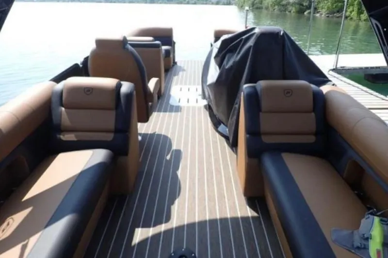 Slide: The Image of 2025 Premier 250 Solaris RF boat interior with luxurious seating on a serene lake. - 4