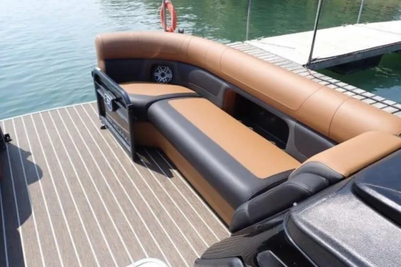 Slide: The Image of 2025 Premier 250 Solaris RF boat with luxurious seating on a wooden deck. - 9