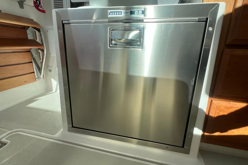 Slide: The Image of 2024 Back Cove 34O boat on water under a partly cloudy sky. - 12