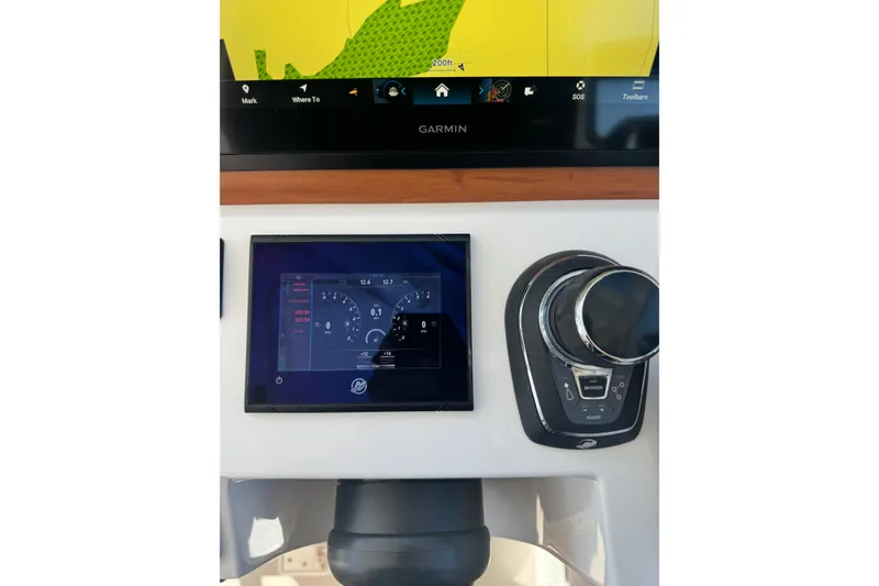 Slide: The Image of 2024 Back Cove 34O boat cruising on a sunny day with bridge in background. - 17