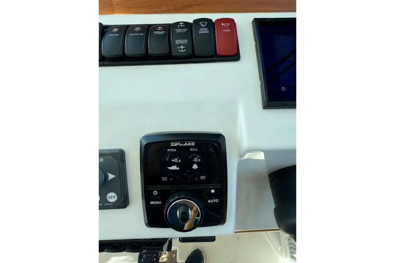 Slide: The Image of 2024 Back Cove 34O boat on calm water under a partly cloudy sky. - 18