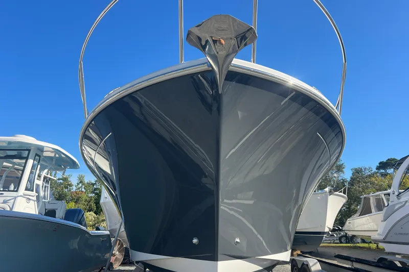 Slide: The Image of 2024 Back Cove 34O boat on calm water under a blue sky. - 2