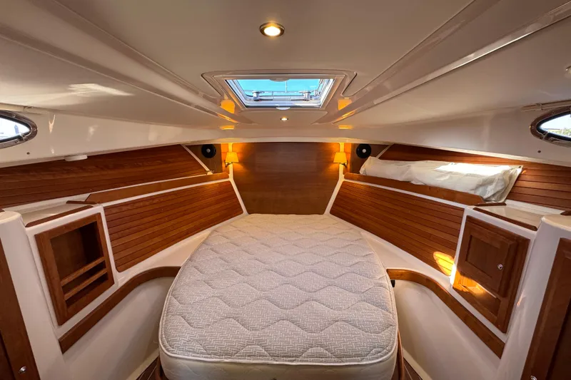 Slide: The Image of 2024 Back Cove 34O helm with navigation display and wooden steering wheel. - 35