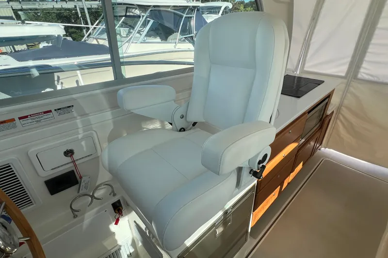 Slide: The Image of Captain's chair in 2024 Back Cove 34O yacht cockpit, featuring sleek design and modern amenities. - 41