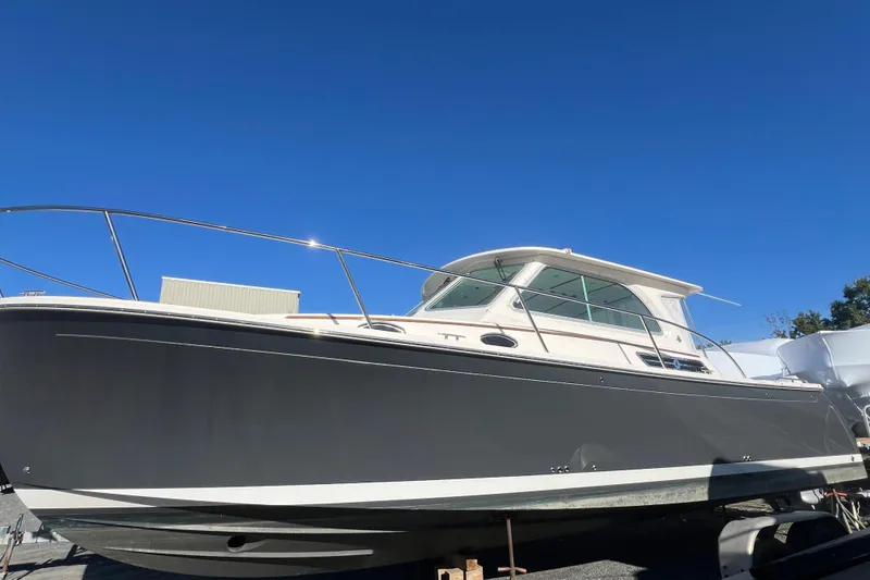 Slide: The Image of 2024 Back Cove 34O boat with sleek design under clear blue sky. - 56