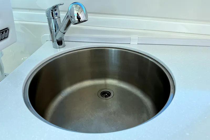 Slide: The Image of 2024 Back Cove 34O boat on calm water under a partly cloudy sky. - 9