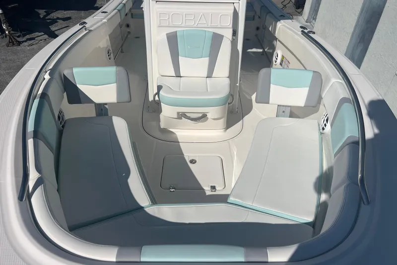 Slide: The Image of 2024 Robalo R232 Explorer boat interior with white and teal seating arrangement. - 13