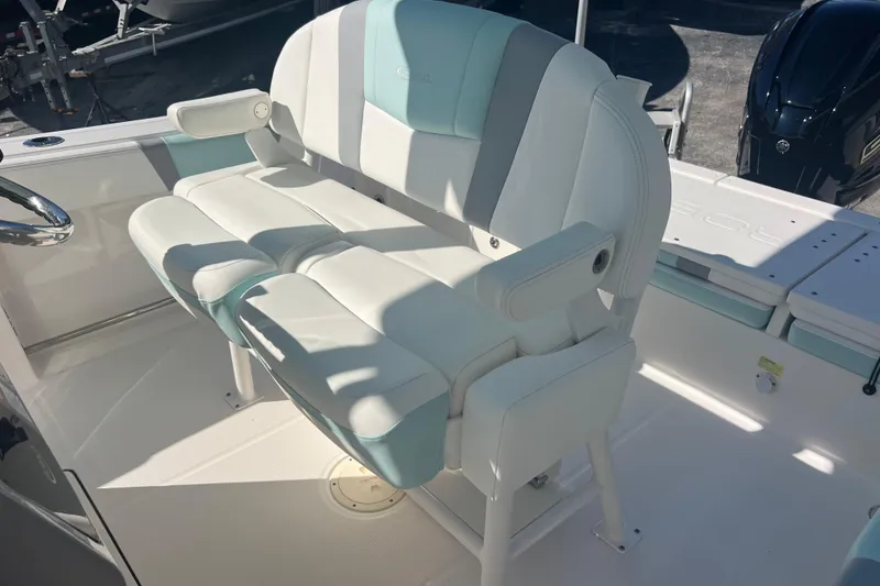 Slide: The Image of 2024 Robalo R232 Explorer boat interior with cushioned seating and armrests. - 17