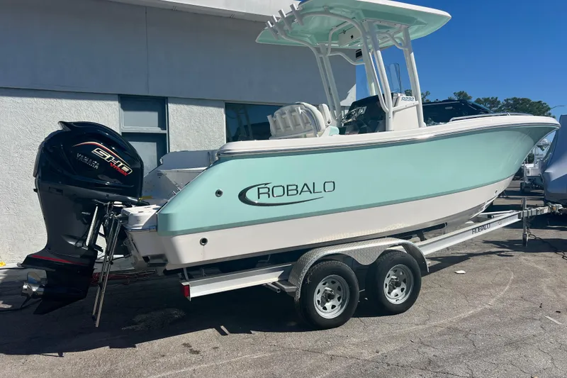 Slide: The Image of 2024 Robalo R232 Explorer boat on trailer, featuring Yamaha engine. - 3