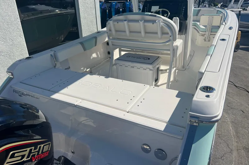 Slide: The Image of 2024 Robalo R232 Explorer boat interior with seating and console, featuring a powerful engine. - 6