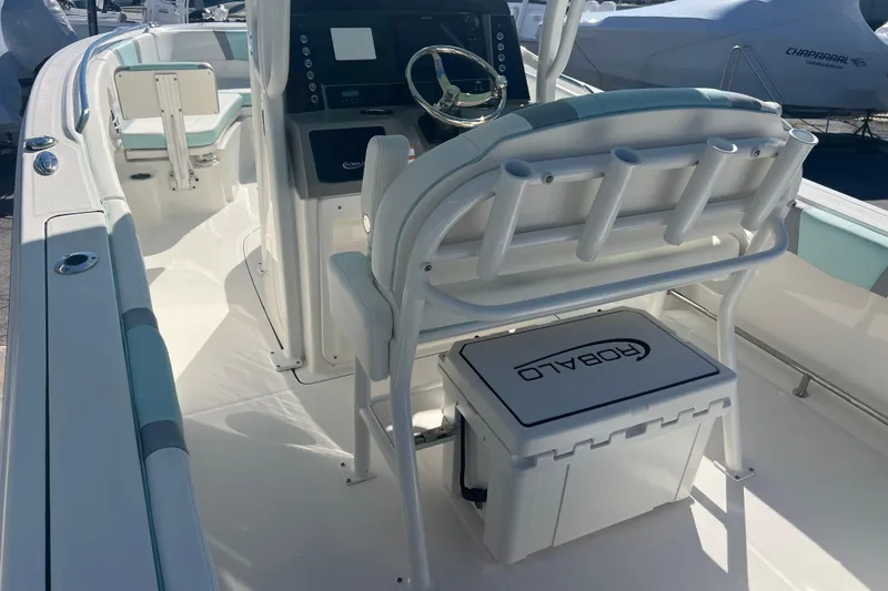 Slide: The Image of 2024 Robalo R232 Explorer boat interior with helm, seating, and storage. - 8