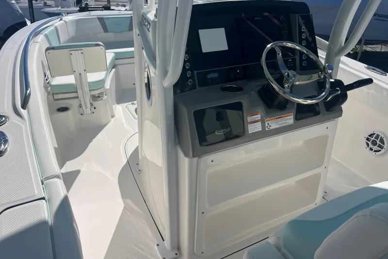 Slide: The Image of 2024 Robalo R232 Explorer boat interior with steering console and seating. - 9