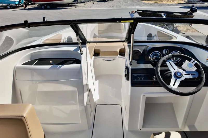 Slide: The Image of 2025 Bayliner VR4 Bowrider OB interior with steering wheel and dashboard view. - 10