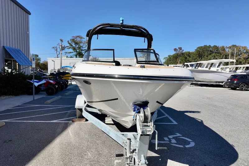 Slide: The Image of 2025 Bayliner VR4 Bowrider OB on trailer in parking lot, sunny day. - 2