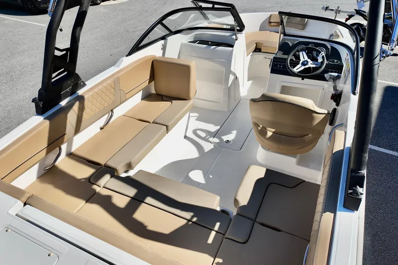 Slide: The Image of 2025 Bayliner VR4 Bowrider OB interior with tan seating and modern dashboard. - 3
